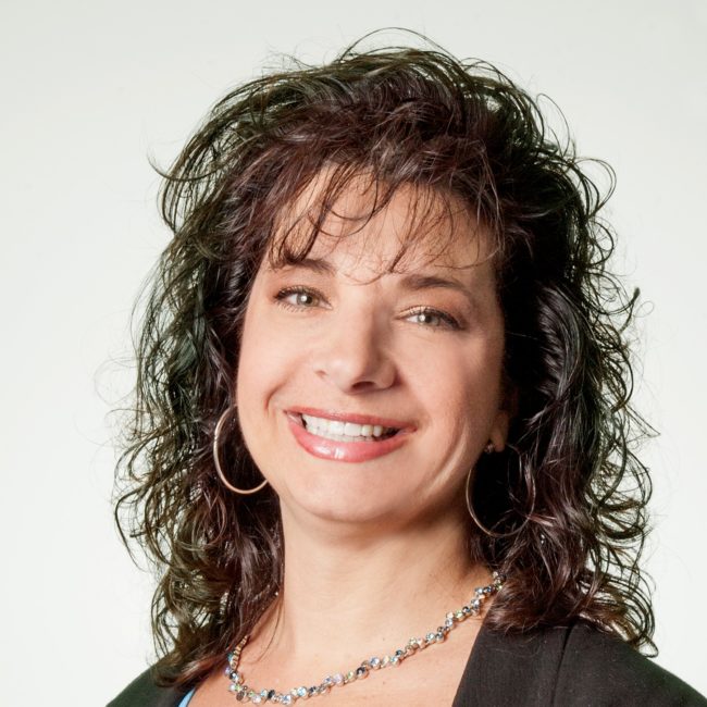 Smiling woman with curly hair and necklace Smiling woman with curly hair and necklace