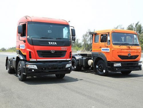 Two Tata cab chassis trucks parked on road