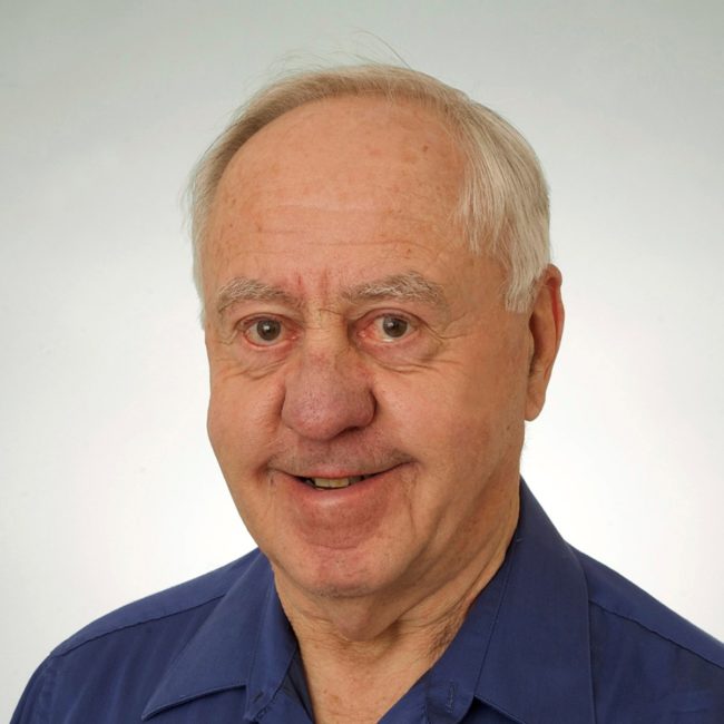 Smiling person wearing blue collared shirt Smiling person wearing blue collared shirt